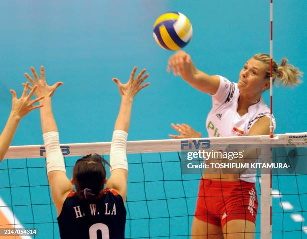Malgorzata Glinka-Mogentale of Poland spikes the ball over South Korean La Hea-Won during their 2008 World Women Olympic qualification tournament...