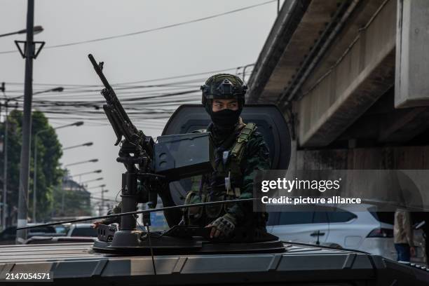 Dpatop - 11 April 2024, Thailand, Mae Sot: A Thai soldier looks out of an armored vehicle in the town on the border with Manmar. In the crisis-hit...