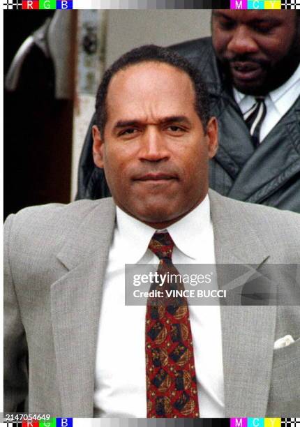 Defendant O.J. Simpson leaves Santa Monica, CA, Superior Court 23 January during a break in his wrongful death civil trial filed by the families of...