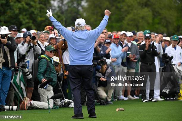 Honorary Starter Jack Nicklaus raises his arms in the air after hitting his tee shot for the Honorary starters ceremony during the first round of...