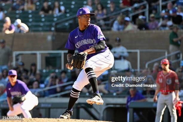 Juan Mejia of the Colorado Rockies throws a pitch during the eighth inning of a spring training game against the Cincinnati Reds at Salt River Fields...