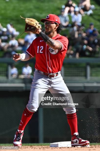 Miguel Hernandez of the Cincinnati Reds covers as Aaron Schunk of the Colorado Rockies runs out a double during the eighth inning of a spring...