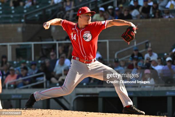 Julian Aguiar of the Cincinnati Reds throws a pitch during the eighth inning of a spring training game against the Colorado Rockies at Salt River...