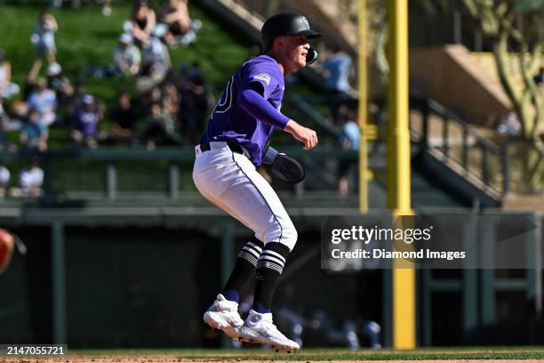 Aaron Schunk of the Colorado Rockies takes a lead at second base during the eighth inning of a spring training game against the Cincinnati Reds at...