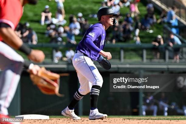 Aaron Schunk of the Colorado Rockies takes a lead at second base during the eighth inning of a spring training game against the Cincinnati Reds at...