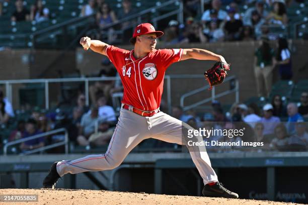Julian Aguiar of the Cincinnati Reds throws a pitch during the eighth inning of a spring training game against the Colorado Rockies at Salt River...