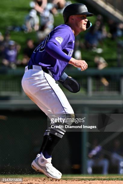 Aaron Schunk of the Colorado Rockies takes a lead at second base during the eighth inning of a spring training game against the Cincinnati Reds at...