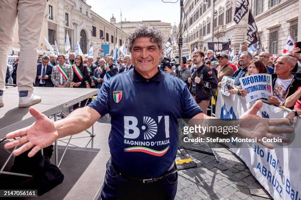 The 'Lifeguard of Italy' Gabriele Pagliarani from Bagno 26 Tiki, Rimini poses as people attend a National demonstration involving the associations...