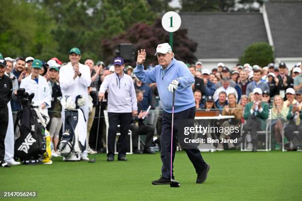 Honorary Starter Jack Nicklaus waves after hitting his tee shot for the Honorary starters ceremony during the first round of Masters Tournament at...