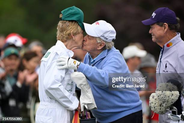 Honorary starter and six-time Masters champion, Jack Nicklaus, giveshis caddie/wife, Barbara a kiss, during the Honorary starters ceremony prior to...