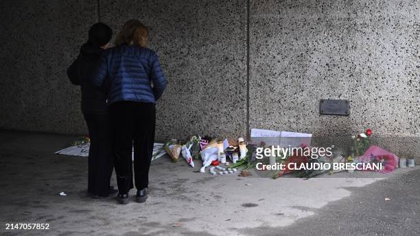 People stand at a makeshift memorial near the center of Skaerholmen, south of Stockholm, Sweden, on April 11, 2024 where a father was shot dead in an...