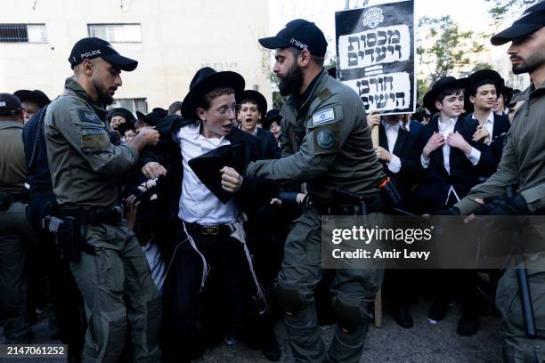 Ultra-Orthodox Jews clash with police officers during a demonstration against drafting to the IDF on April 11, 2024 in Jerusalem. Haredi men of...