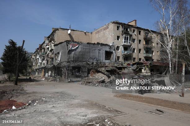 Man walks past an apartment building destroyed in the town of Kostyantynivka, Donetsk region, on April 11 amid the Russian invassion in Ukraine.