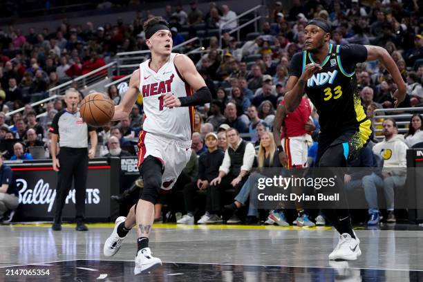 Tyler Herro of the Miami Heat dribbles the ball while being guarded by Myles Turner of the Indiana Pacers in the second quarter at Gainbridge...