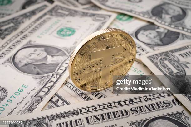 a shiny gold tether coin - us currency stock pictures, royalty-free photos & images