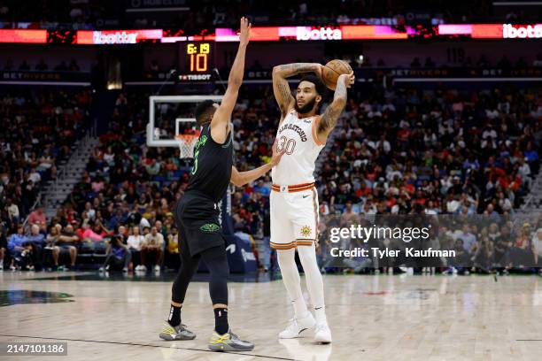 Julian Champagnie of the San Antonio Spurs is defended by CJ McCollum of the New Orleans Pelicans during a game at Smoothie King Center on April 05,...