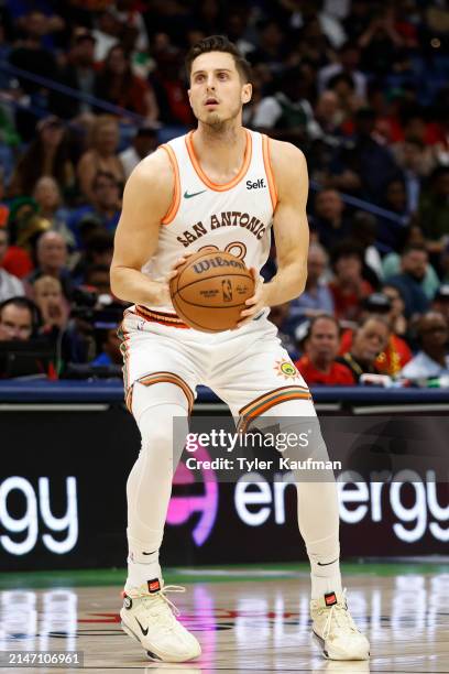 Zach Collins of the San Antonio Spurs takes a shot during a game against the New Orleans Pelicans at Smoothie King Center on April 05, 2024 in New...