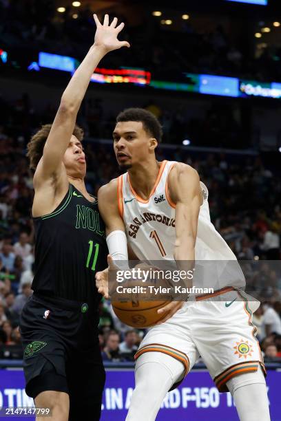 Victor Wembanyama of the San Antonio Spurs is defended by Dyson Daniels of the New Orleans Pelicans during a game at Smoothie King Center on April...