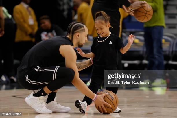 Jose Alvarado of the New Orleans Pelicans warms up with his daughter prior to a game against the San Antonio Spurs at Smoothie King Center on April...