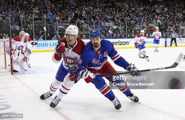 Justin Barron of the Montreal Canadiens skates against Chris Kreider of the New York Rangers during the second period at Madison Square Garden on...