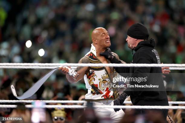 Dwayne "The Rock" Johnson fights against The Undertaker during Night Two at Lincoln Financial Field on April 07, 2024 in Philadelphia, Pennsylvania.