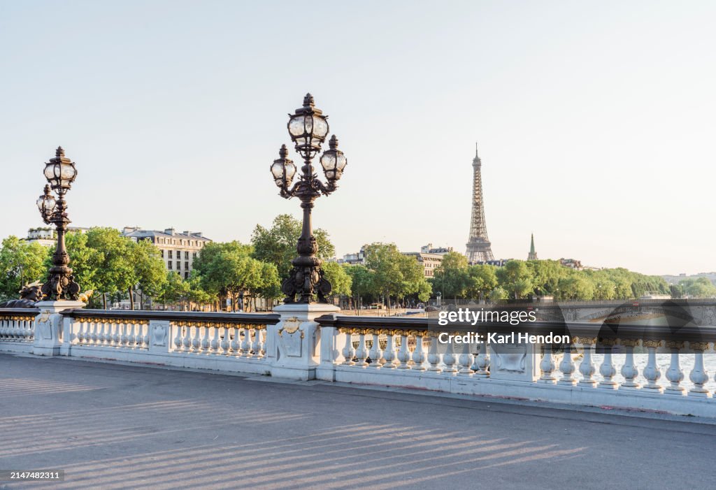 A sunset view of a Paris bridge
