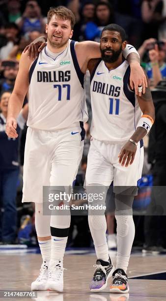 Luka Doncic and Kyrie Irving of the Dallas Mavericks embrace after defeating the against the Houston Rockets in overtime at American Airlines Center...