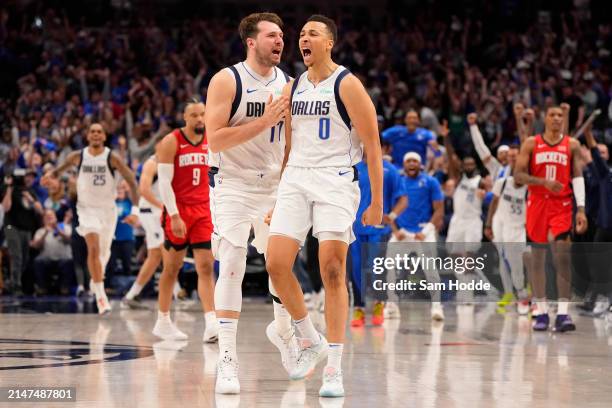 Dante Exum of the Dallas Mavericks celebrates with Luka Doncic after making a buzzer beater 3-pt basket to tie the game in the fourth quarter and...