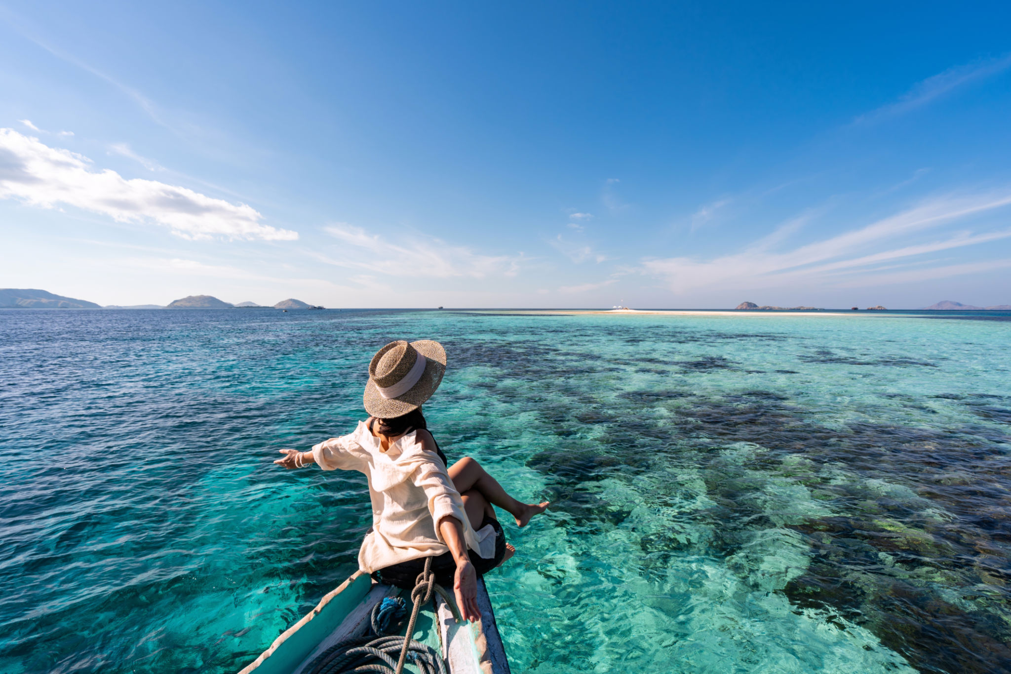 Young woman traveler relaxing and enjoying the tropical sea while traveling for summer vacation, Travel lifestyle concept Young woman traveler relaxing and enjoying the tropical sea while traveling for summer vacation, Travel lifestyle concept