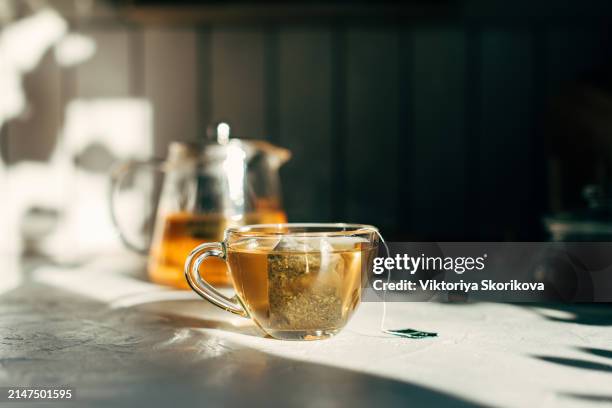 cup of tea with tea bag on a gray background. - tea bag stock pictures, royalty-free photos & images