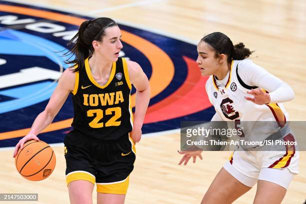 Caitlin Clark of the Iowa Hawkeyes dribbles the ball during the second half at the 2024 NCAA Women's Basketball Tournament championship game between...
