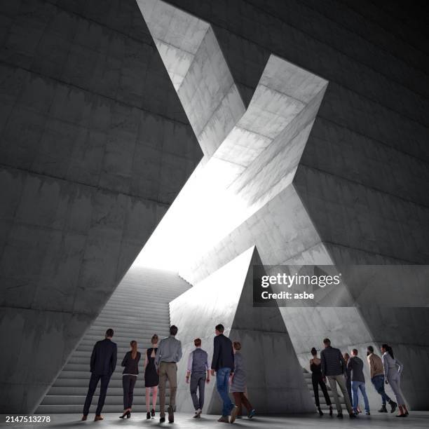 people entering the cross shaped wall - cross shape stock pictures, royalty-free photos & images