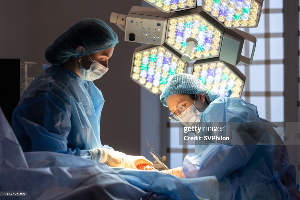 The plastic surgeon and the surgical nurse perform the operation.