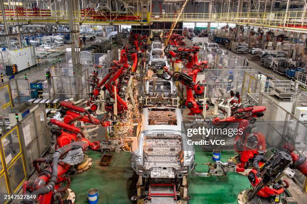 Robotic arms work at an intelligent factory of electric vehicle enterprise Leapmotor on April 8, 2024 in Jinhua, Zhejiang Province of China.