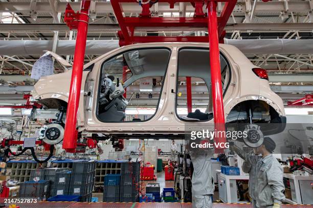 Employees assemble new energy vehicles at an intelligent factory of electric vehicle enterprise Leapmotor on April 8, 2024 in Jinhua, Zhejiang...