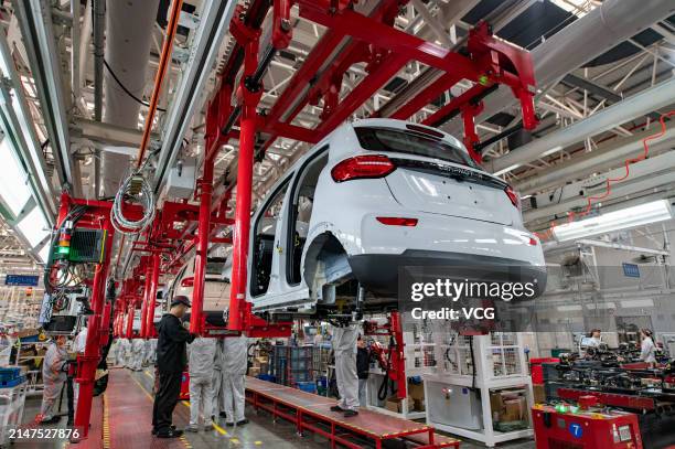 Employees work at an intelligent factory of electric vehicle enterprise Leapmotor on April 8, 2024 in Jinhua, Zhejiang Province of China.