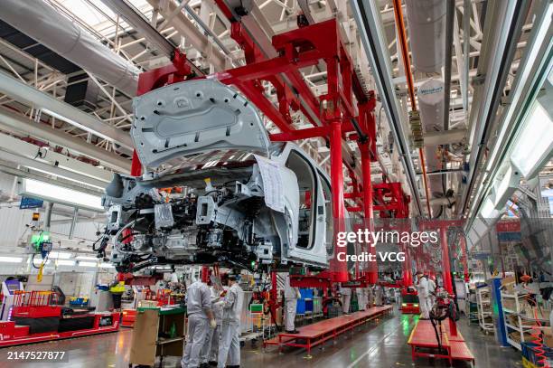 Employees assemble new energy vehicles at an intelligent factory of electric vehicle enterprise Leapmotor on April 8, 2024 in Jinhua, Zhejiang...