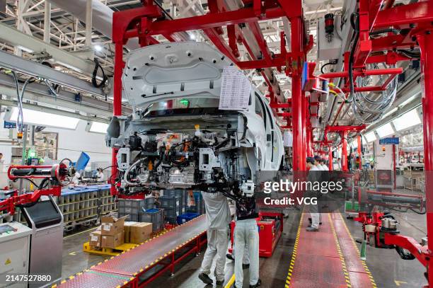 Employees assemble new energy vehicles at an intelligent factory of electric vehicle enterprise Leapmotor on April 8, 2024 in Jinhua, Zhejiang...