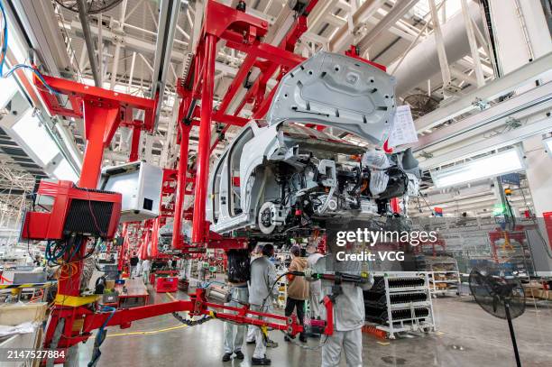 Employees assemble new energy vehicles at an intelligent factory of electric vehicle enterprise Leapmotor on April 8, 2024 in Jinhua, Zhejiang...