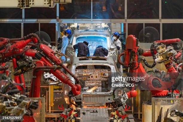 Robotic arms work at an intelligent factory of electric vehicle enterprise Leapmotor on April 8, 2024 in Jinhua, Zhejiang Province of China.