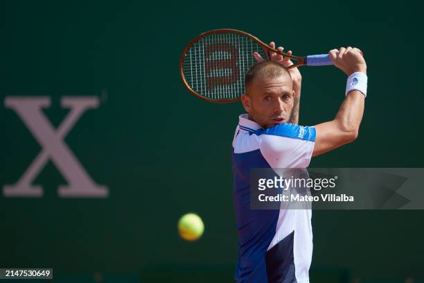 Daniel Evans of United Kingdom plays a backhand against Sebastian Ofner of Austria in their first round match during day two of the Rolex Monte-Carlo...