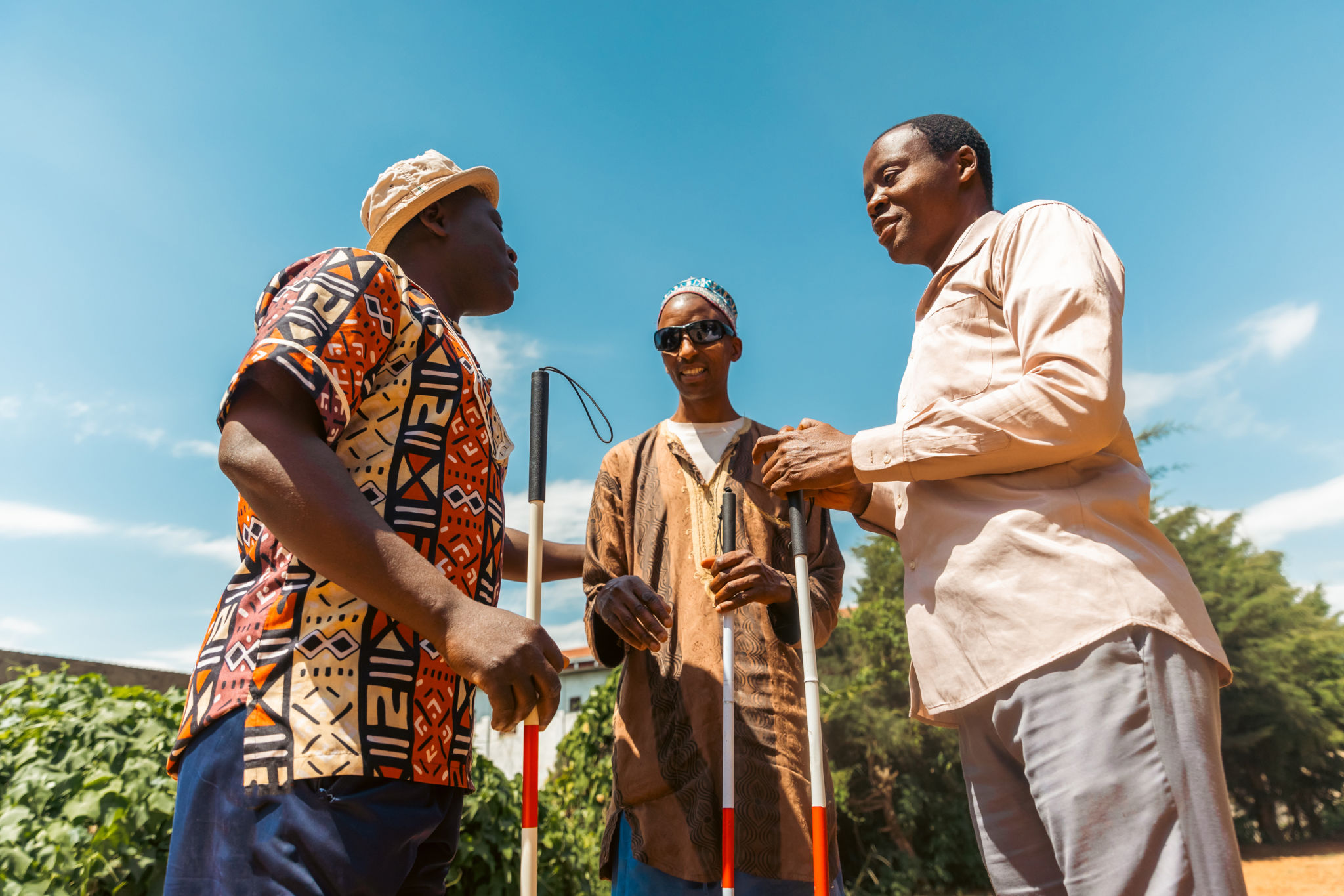 Three blind men are holding a conversation together, friendship between disabled people Three blind men are holding a conversation together, friendship between disabled people