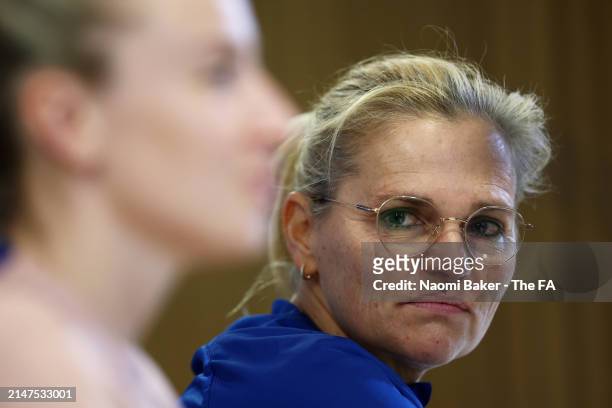 Sarina Wiegman, Head Coach of England, looks on as Leah Williamson of England speaks to the media during an England Press Conference at Aviva Stadium...