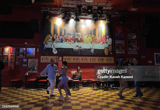 People dance to salsa music in La Topa Tolondra nightclub on January 13, 2024 in Cali, Colombia. Cali is known by the rest of Colombia as the "Rumba...