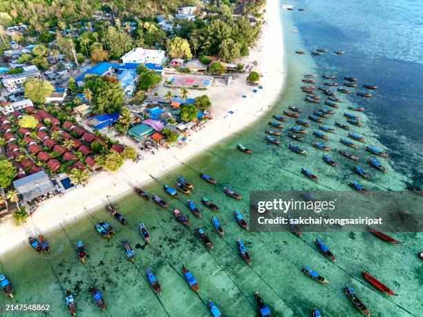 aerial view of longtail boats moored on the beach in koh lipe in thailand - ko lipe stock pictures, royalty-free photos & images