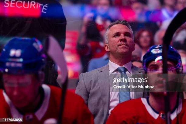 Montreal Canadiens Head Coach Martin St-Louis looks on from behind the bench before the national anthem of the NHL regular season game between the...