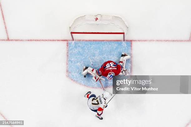 Sam Montembeault of the Montreal Canadiens makes a save on Eetu Luostarinen of the Florida Panthers during the third period of the NHL regular season...