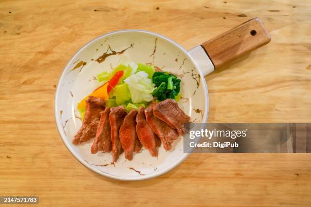 sliced beef tongue with vegetable sides in skillet - dining presentation food fotografías e imágenes de stock