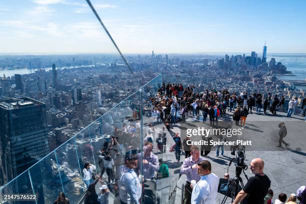 People gather on the observation deck of Edge at Hudson Yards before a partial solar eclipse on April 08, 2024 in New York City. While New York City...