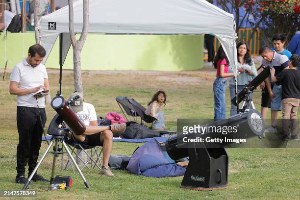 Visitors set up telescopes to see the eclipse at Bosque Urbano on April 8, 2024 in Torreon, Mexico. Millions of people have flocked to areas across...